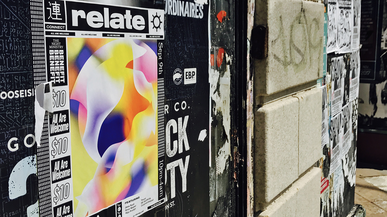 A poster on the side of the street with graffiti and grit